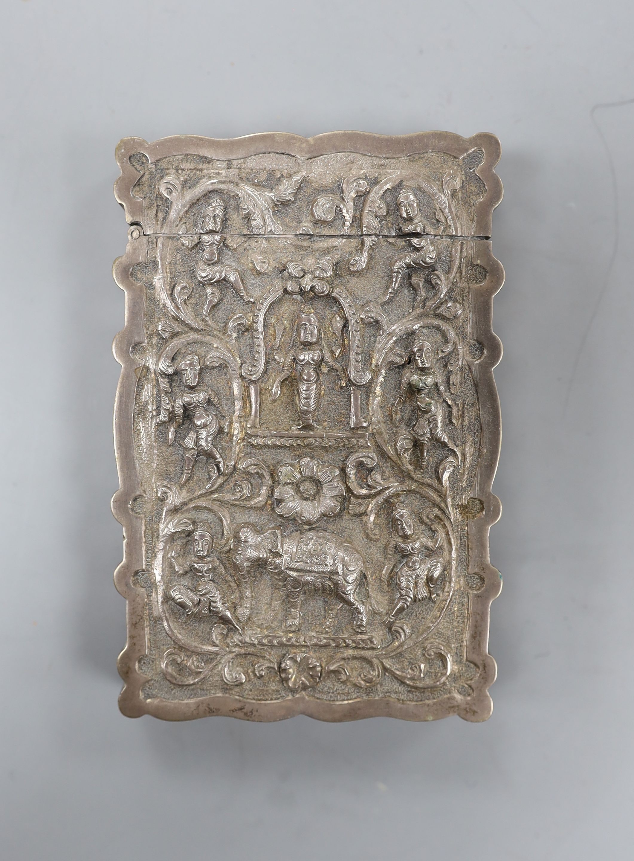 An Indian embossed white metal card case, decorated with figures and elephants, 97mm